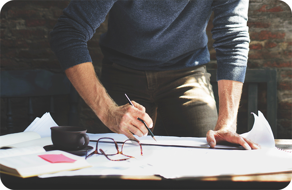 Man working, writing on paper